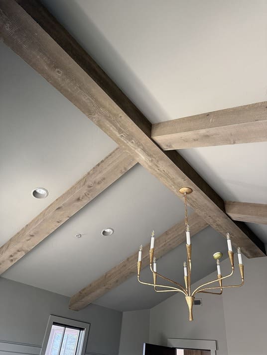 Interior reclaimed wood box beams with chandelier
